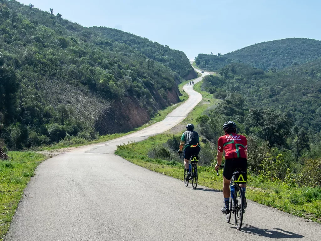 Backgrounds guests biking up hill in Portugal.