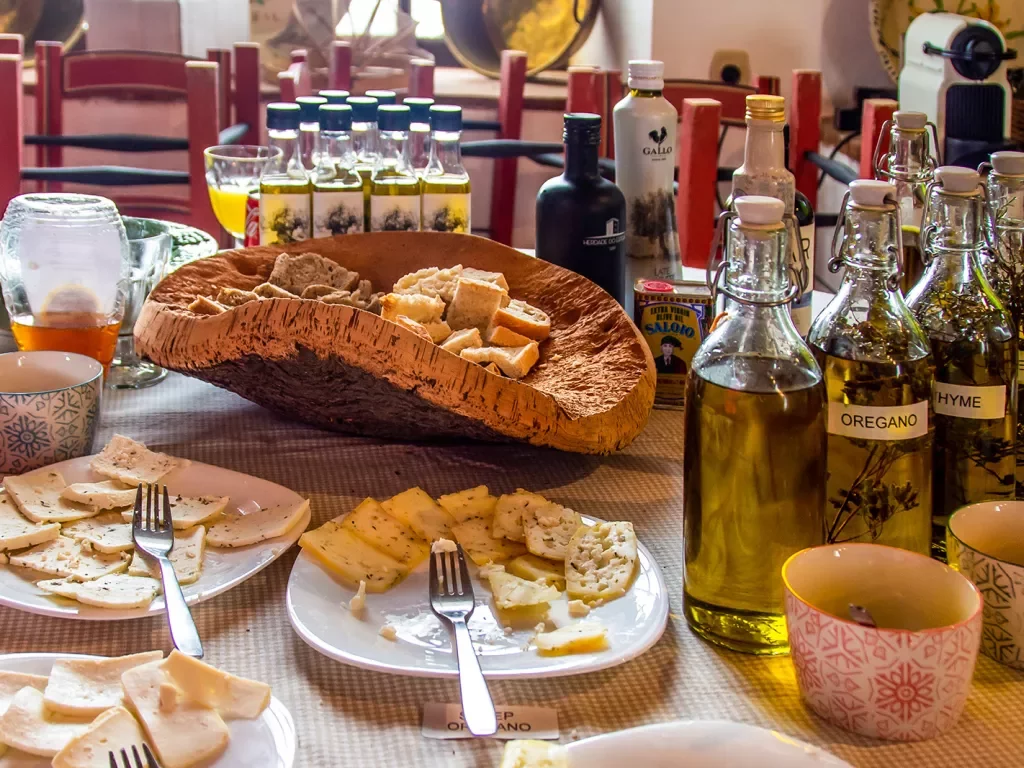 Cheese plates with bottles of olive oil.
