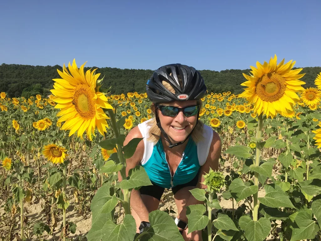 Backroads Guest Smiling in Sunflowers