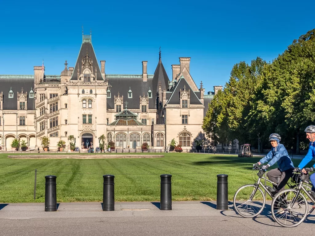 Guests biking in front of the Biltmore Estate.