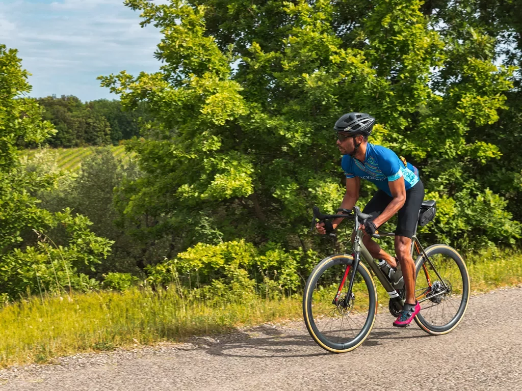 Backroads guest biking through green landscape