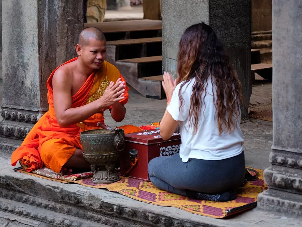 Guest with monk, performing ceremony.