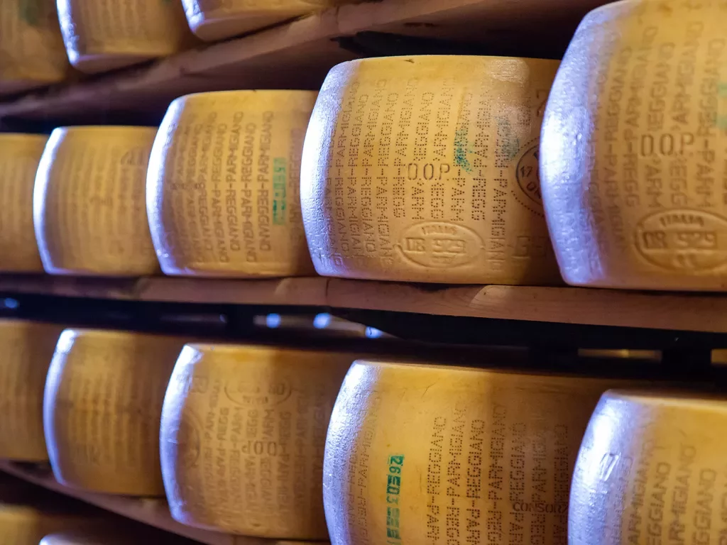 Shelves filled with wheels of Parmigiano Regiano