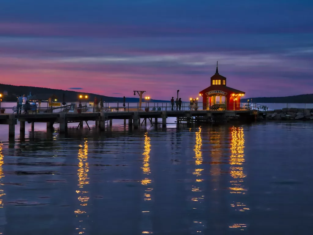 Wide shot of "SENECA LAKE" pier during sunset.