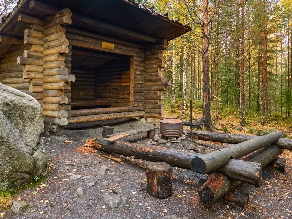 Shot of wooden fire pit, log cabin.