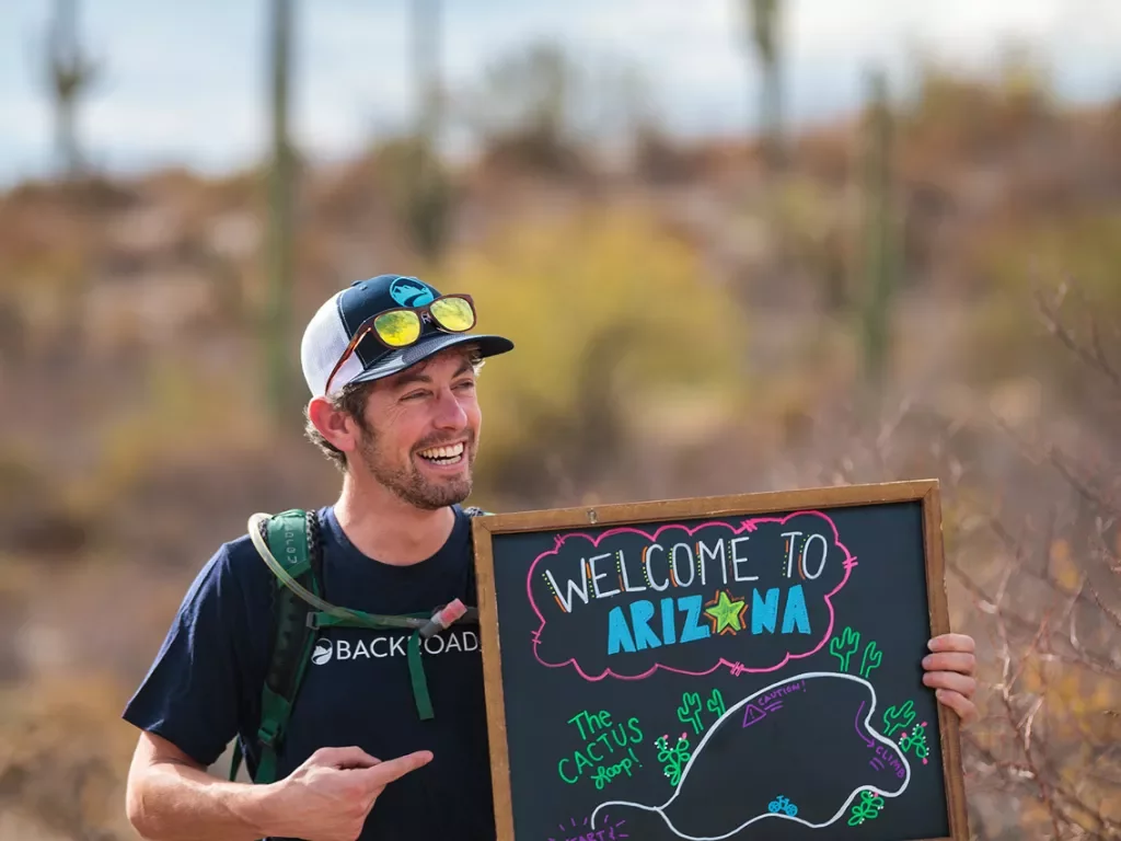 Leader holding a welcome to Arizona sign