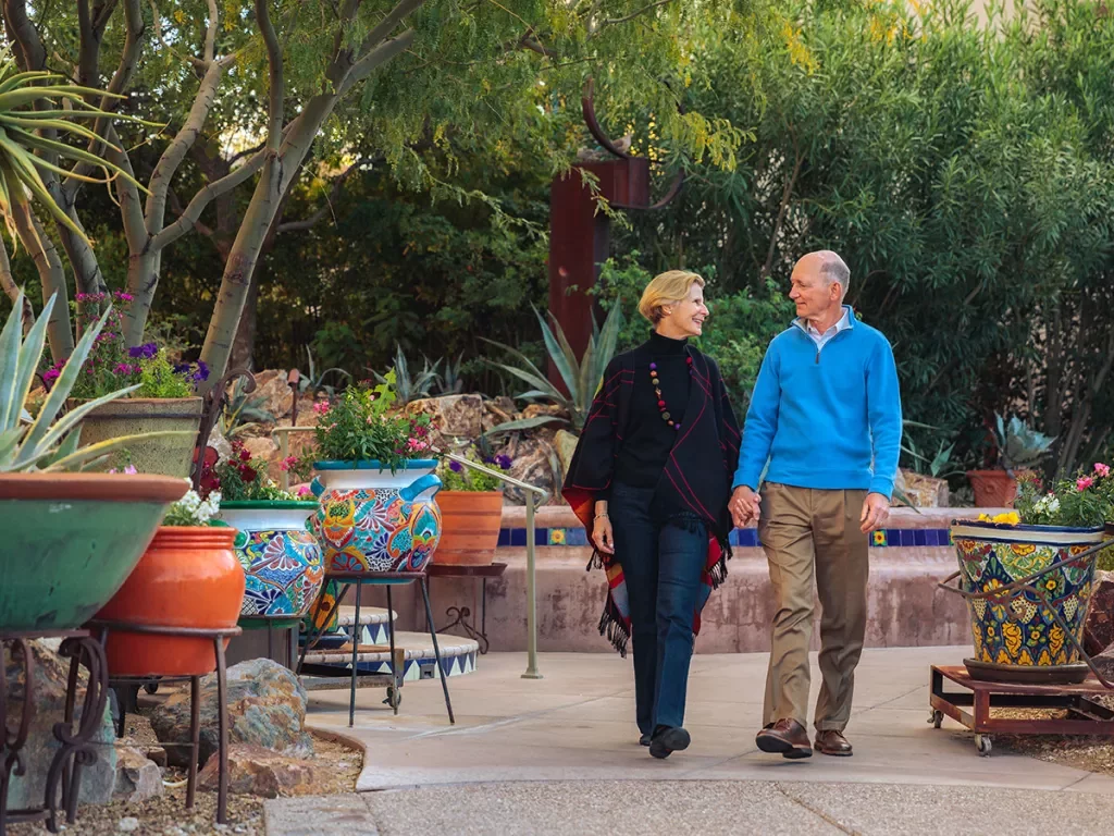 Couple holding hands walking in patio AZ