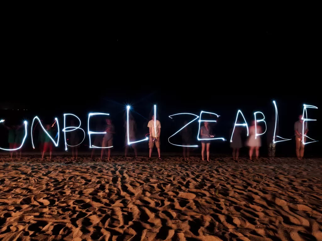 "Unbelizeable" Written by Flash Lights on Beach at Night