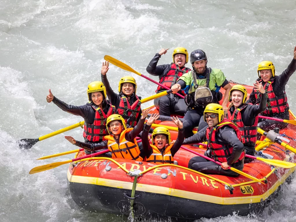 Group of guests white water rafting.