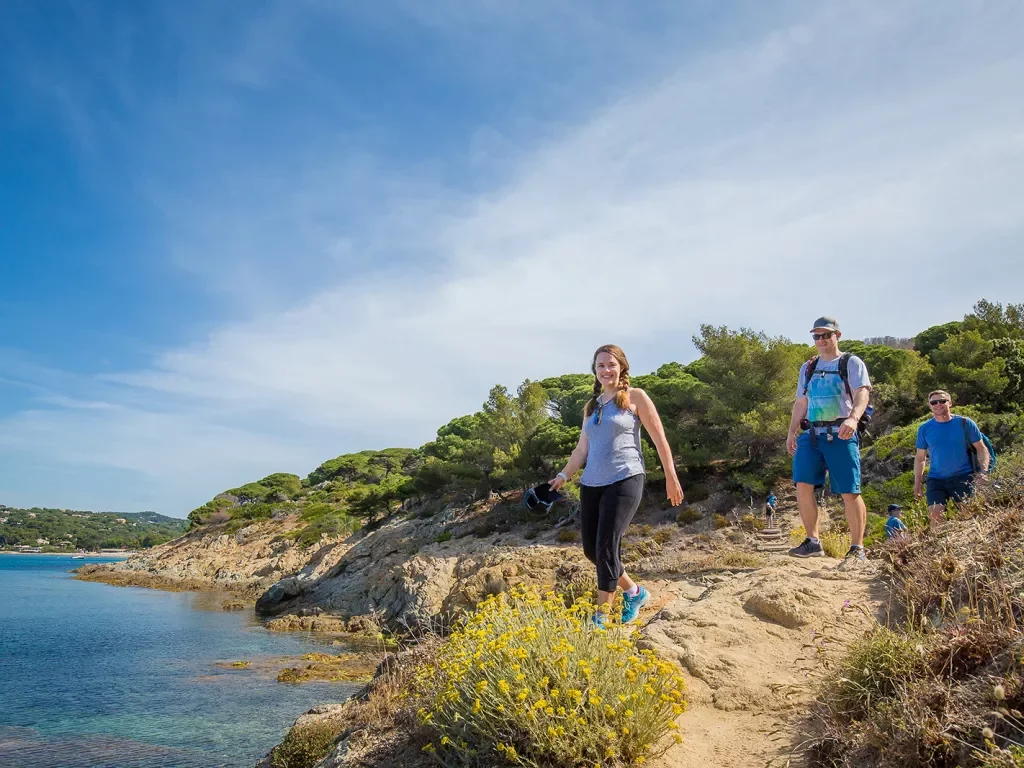 Group of three Backroads guests hiking beside the sea in France