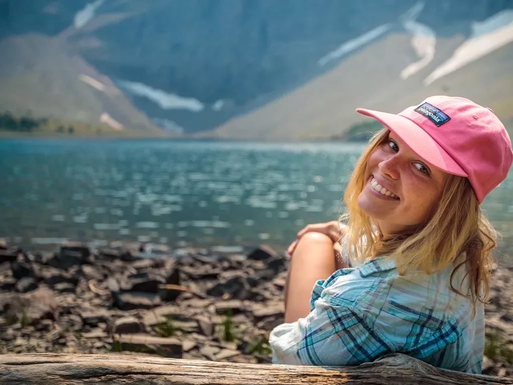 Backroads guest smiling in front of lake and mountains 