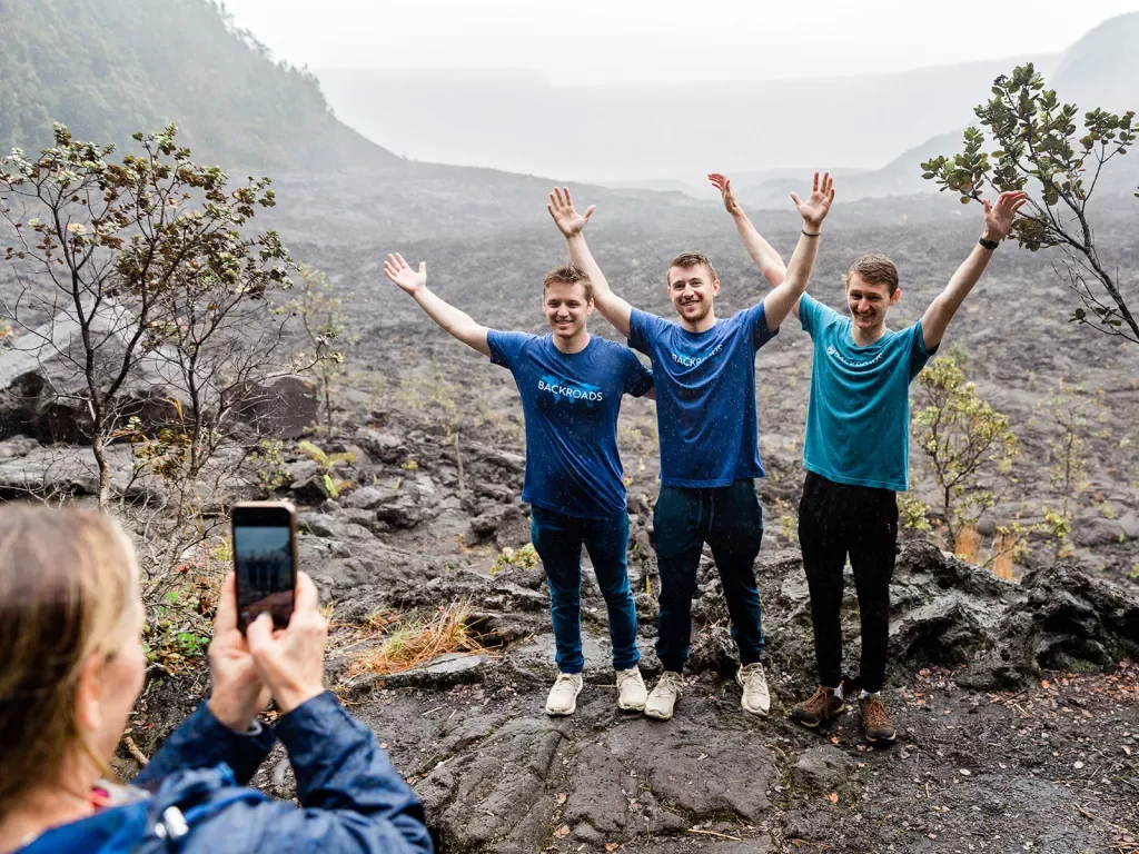 Guests posing for a photo in a lava field in Hawaii