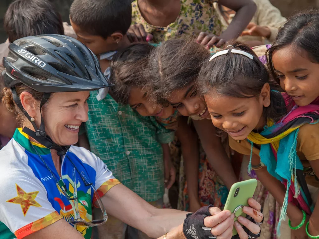 Woman showing her phone to children in India
