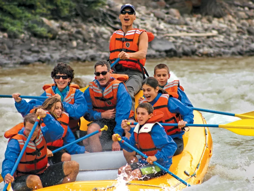 Group of guests white-water rafting.