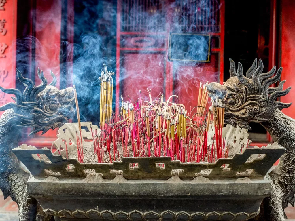 Incense burning in a dragon shaped shrine in Vietnam