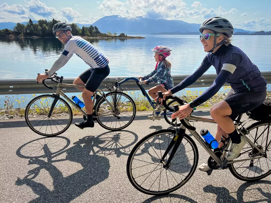 Family Riding Piccolo Along Fjord