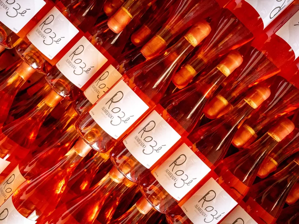 Wall of rose wine bottles.