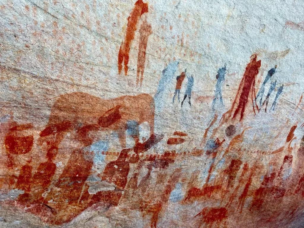Cave drawings of people and elephants