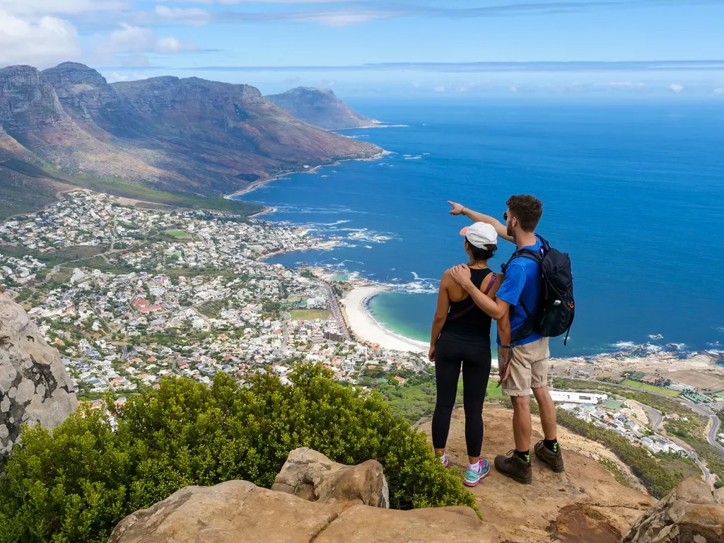 Couple standing on an overlook above a coastal town