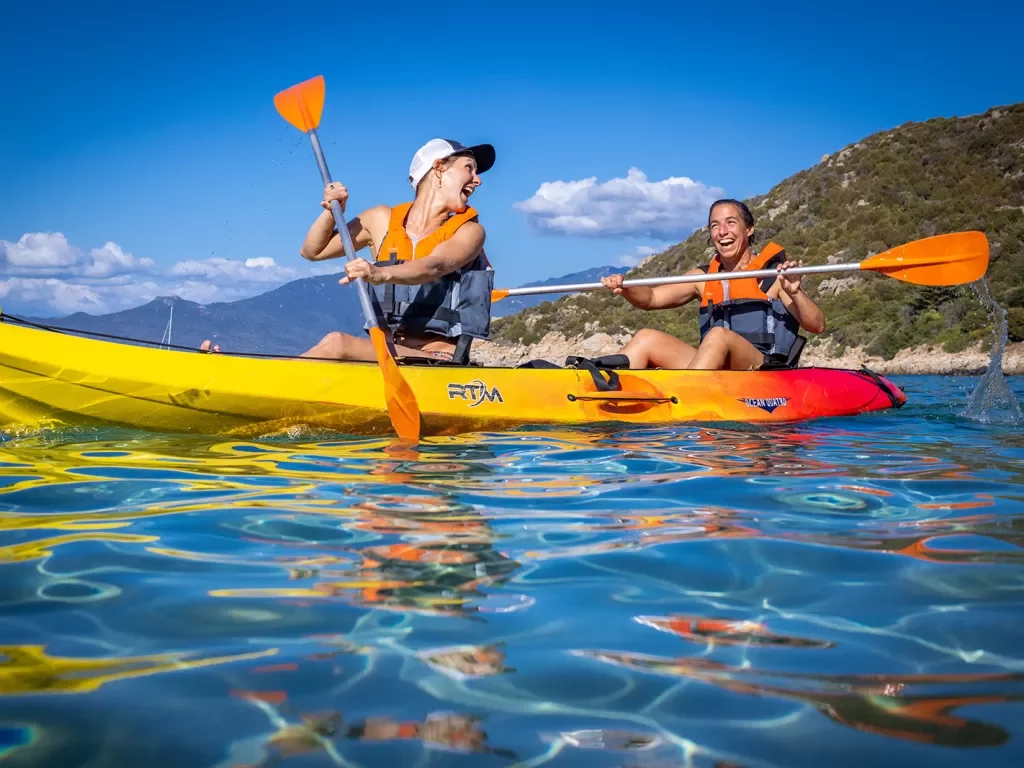Two guests in kayak, smiling and laughing.