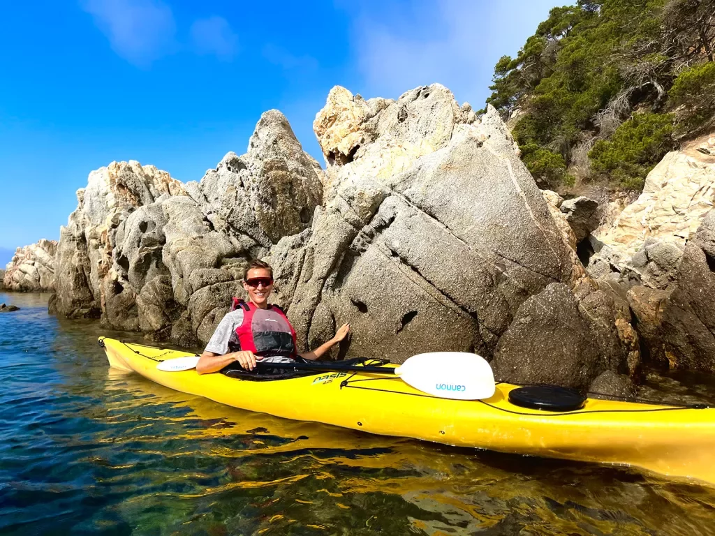 Kayaking among a rocky shore