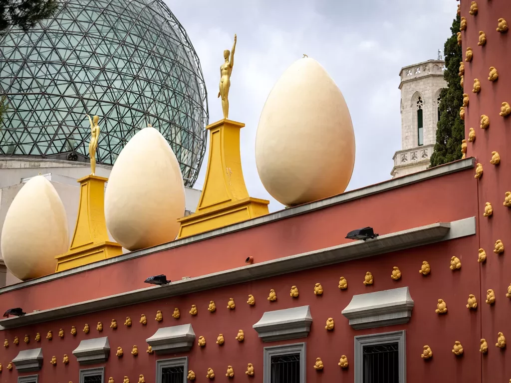 Egg shaped sculptures atop a red building