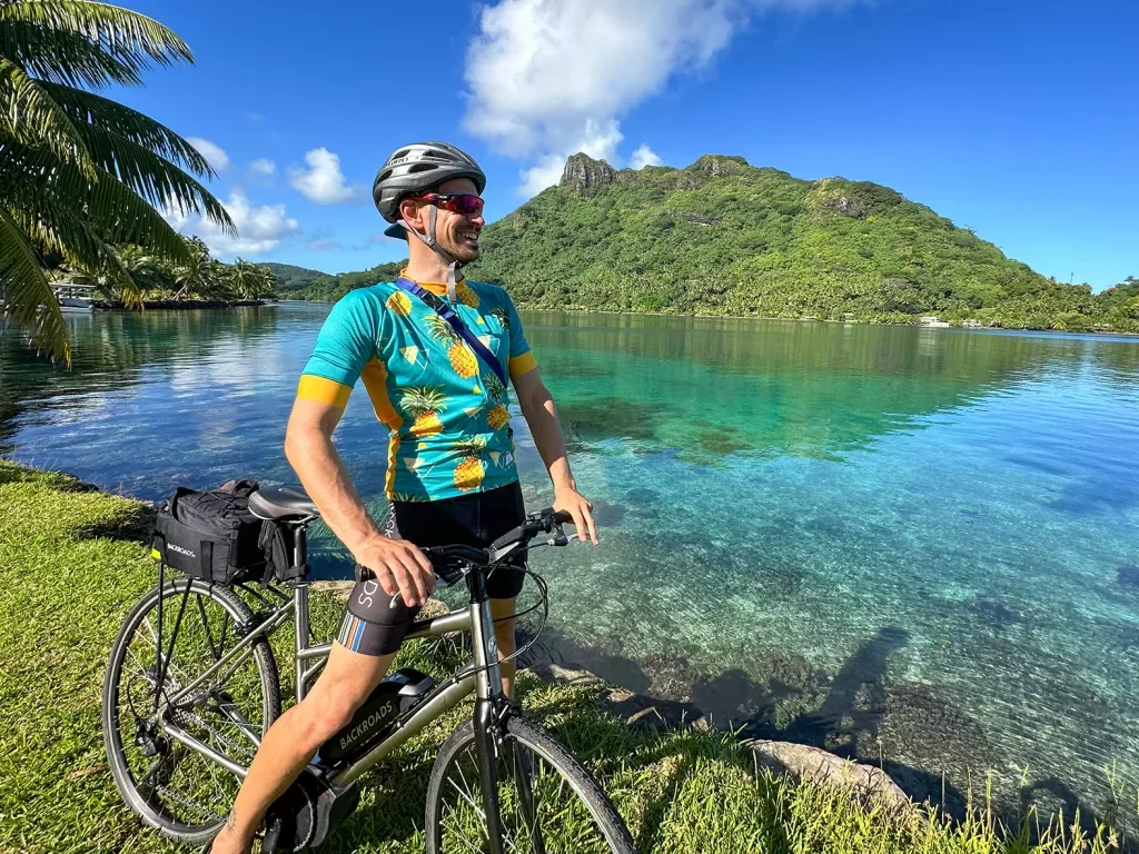 Riding a bike next to a bay in Tahiti
