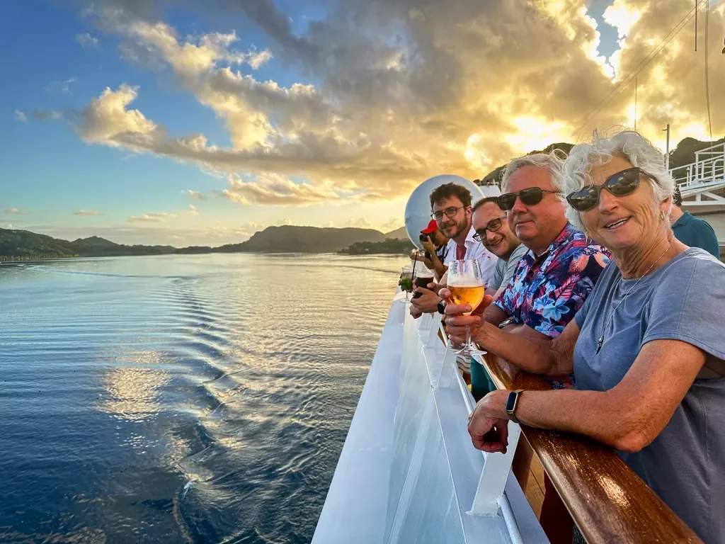 Looking out over the side of a boat in Tahiti at sunset