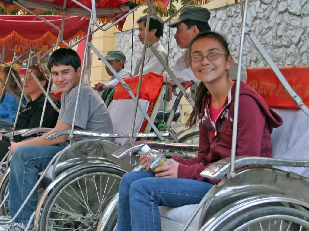 Backroads guests sitting in bike pedal carts in Vietnam