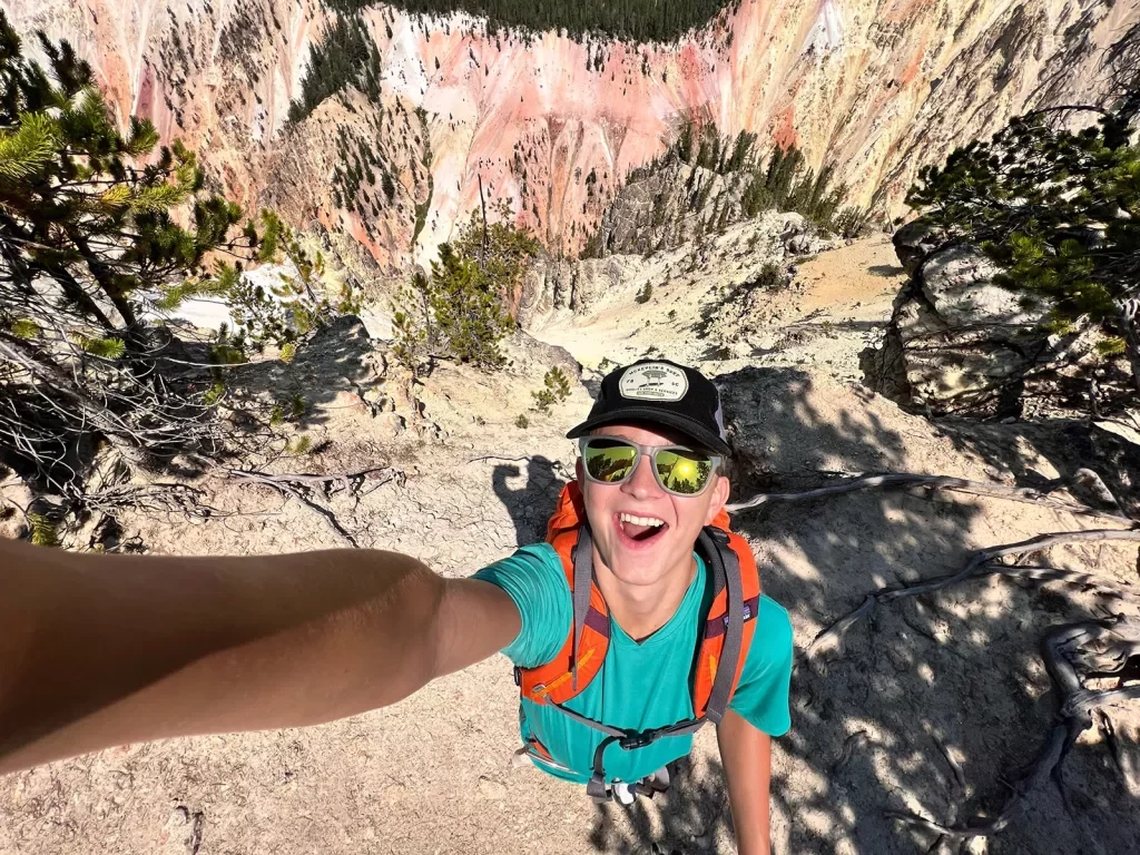Backroads guest taking a selfie at the top of a mountain
