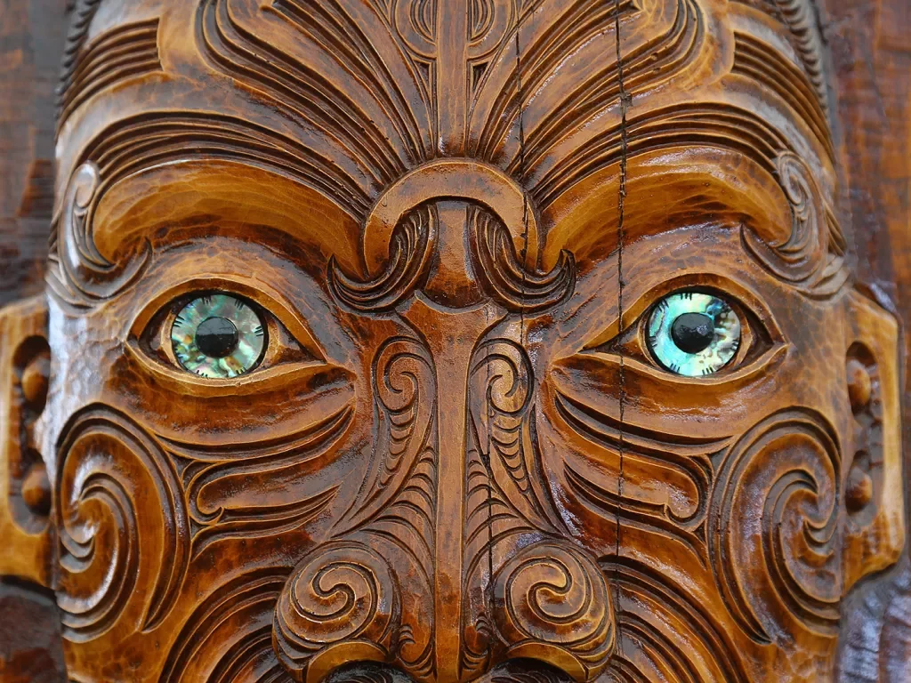 Carved face in Maori style, New Zealand