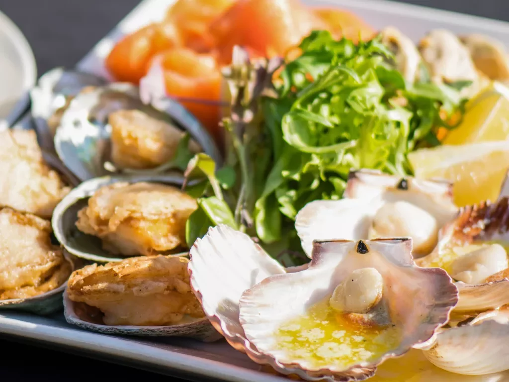 Cooked seafood platter with salad.