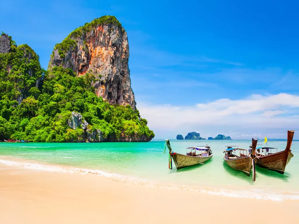 Boats resting on a sandy beach in Thailand