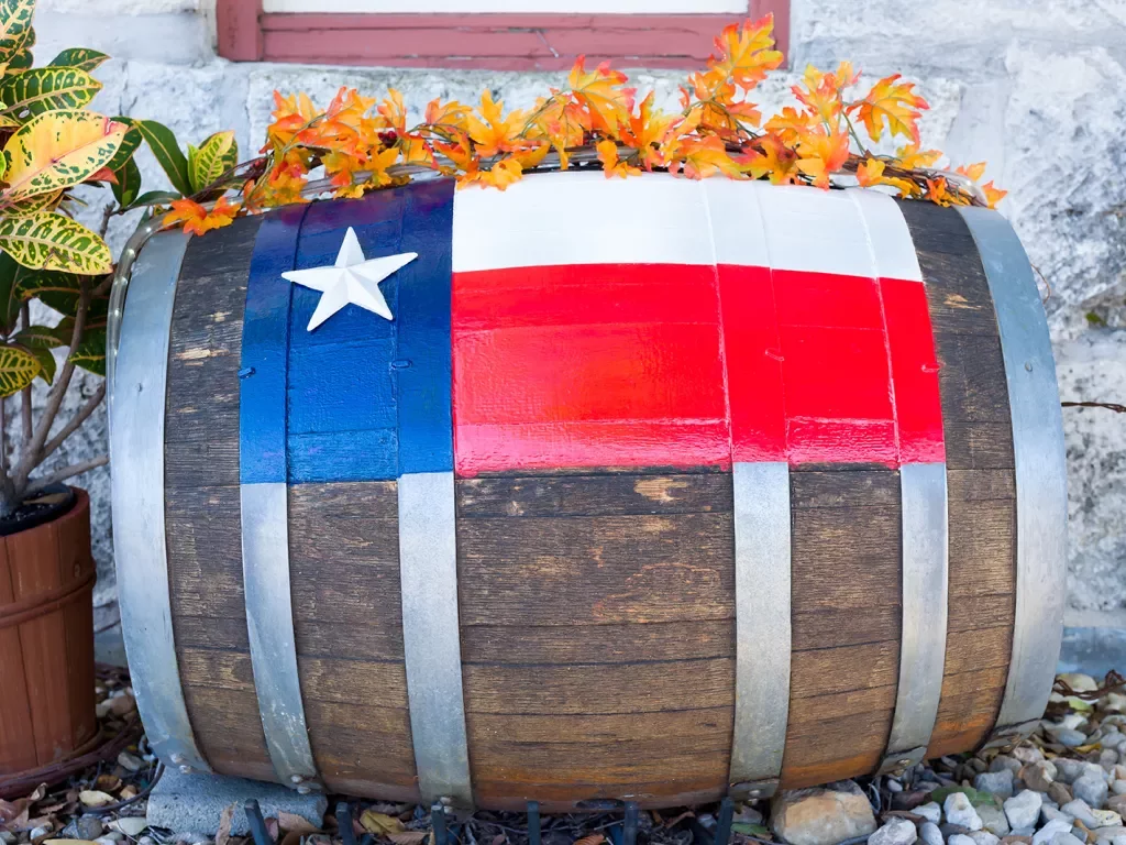 Painted repurposed barrel with orange flowers