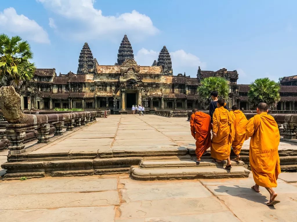Monks walking towards Angkor Wat in Cambodia