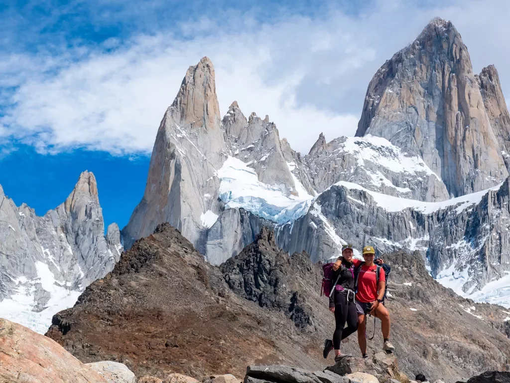 Two hikers posing on top of a rock in Patagonia.
