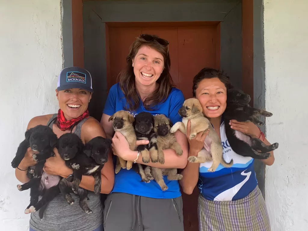 Guests holding puppies in Bhutan