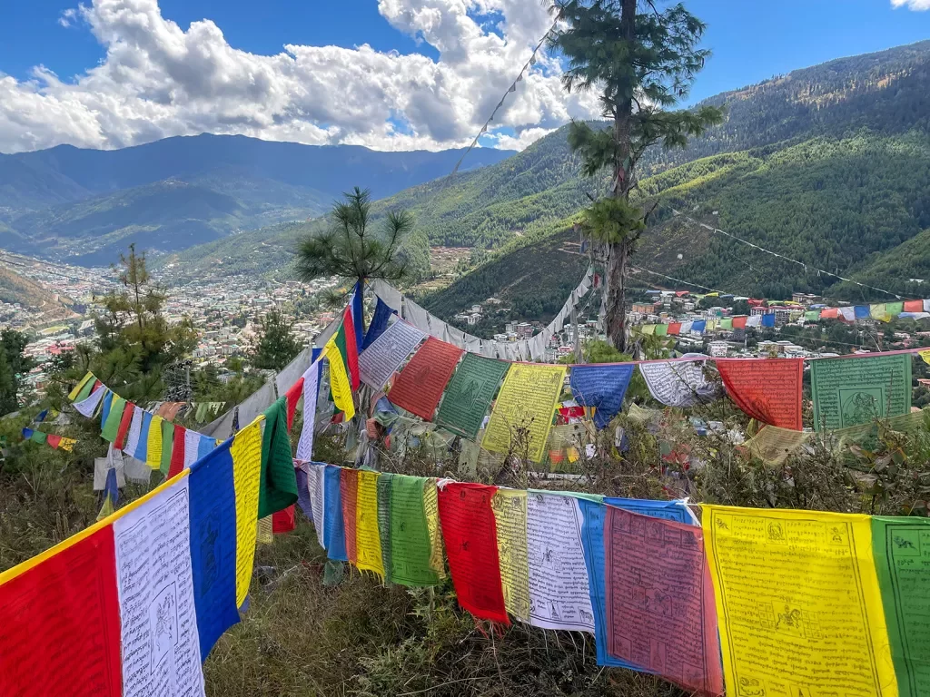 Brightly colored flags strung up above a valley in Bhutan