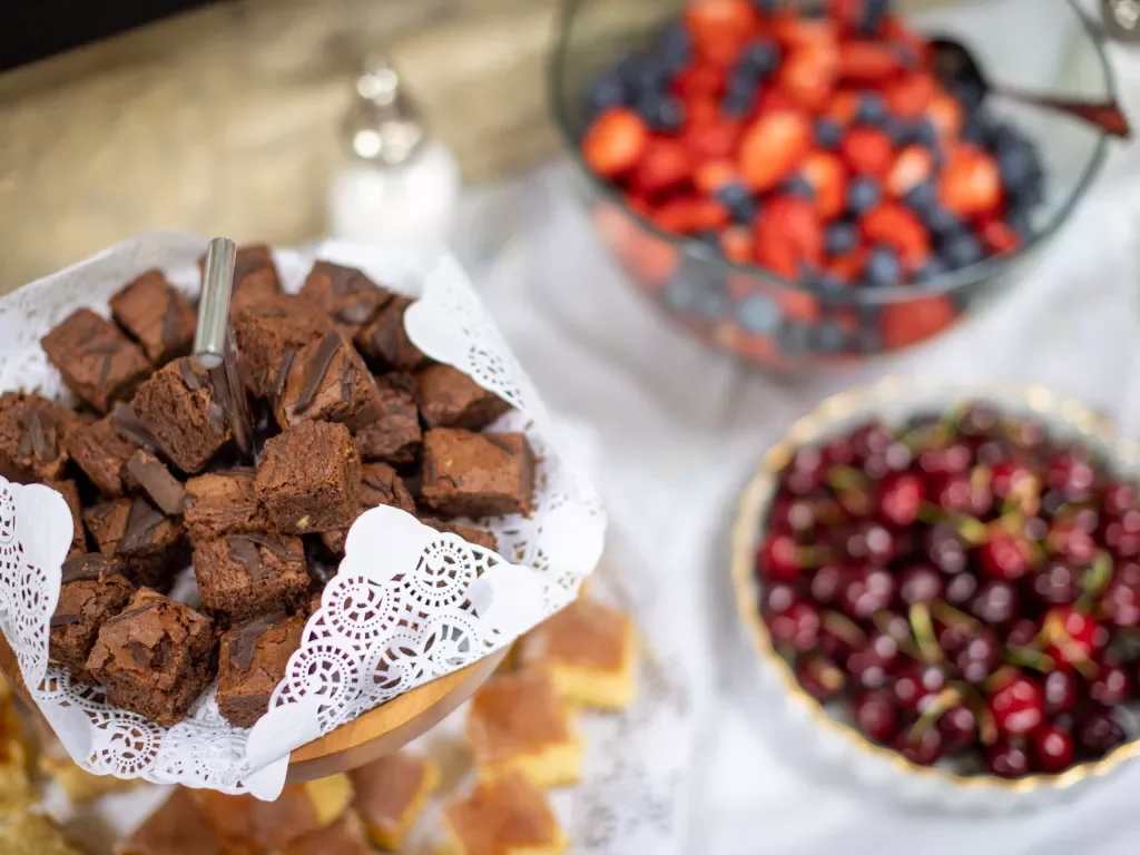 Display of fruit, berries and small brownie bites.