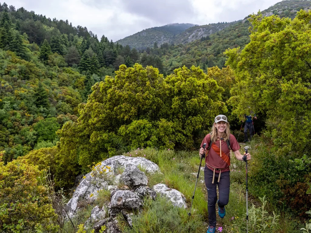 Backroads hiker on trail in dense wilderness in Greece.