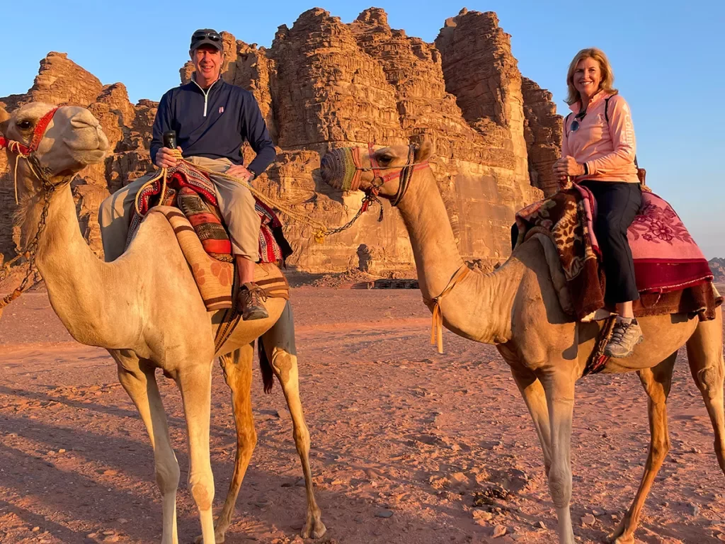 Travelers in desert on camels