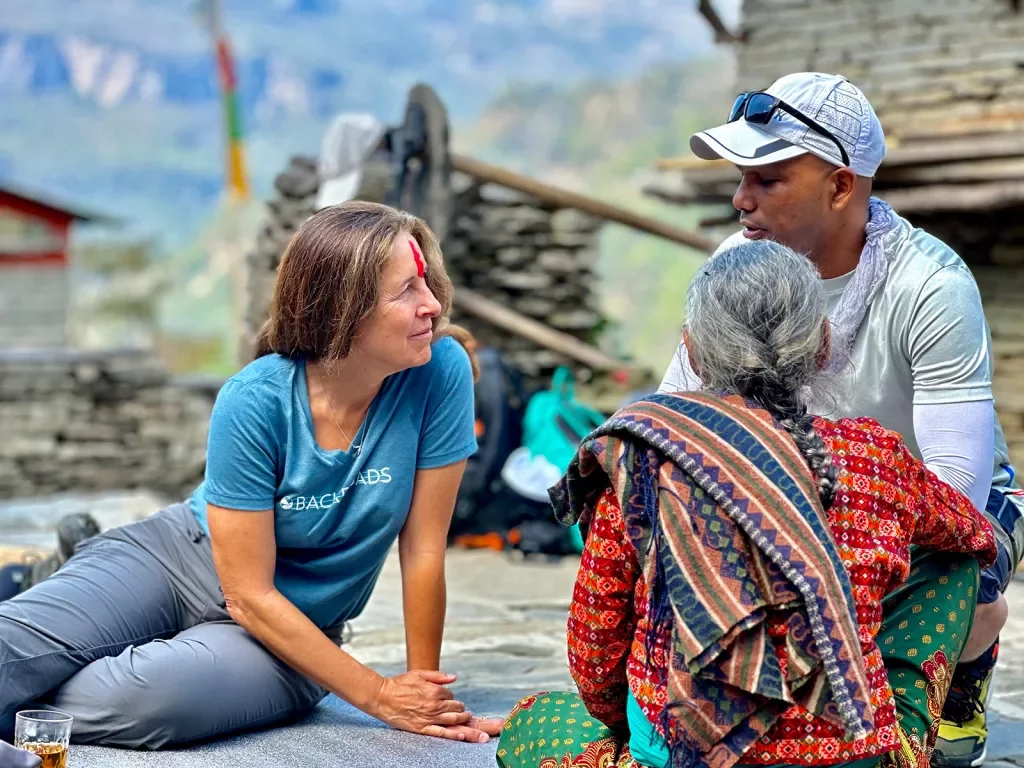 Backroads guests chatting with a local in Nepal