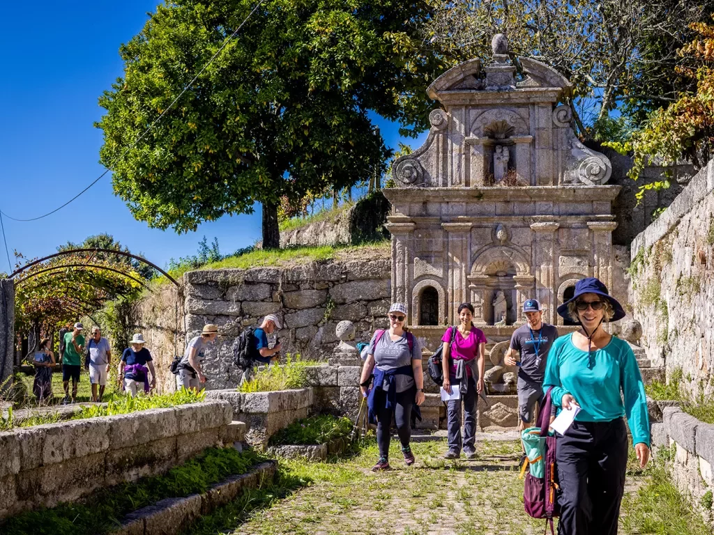 Guests walking among hilly stone ruins.