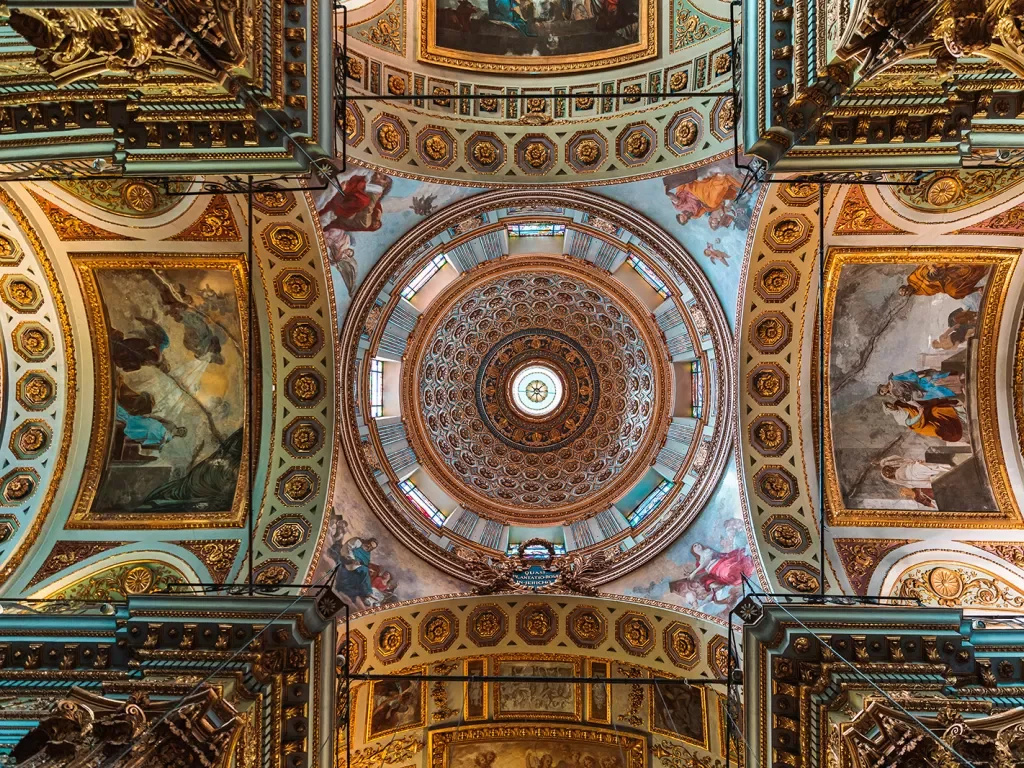 Shot of ceiling in domed church, mosaics and art on ceiling. 