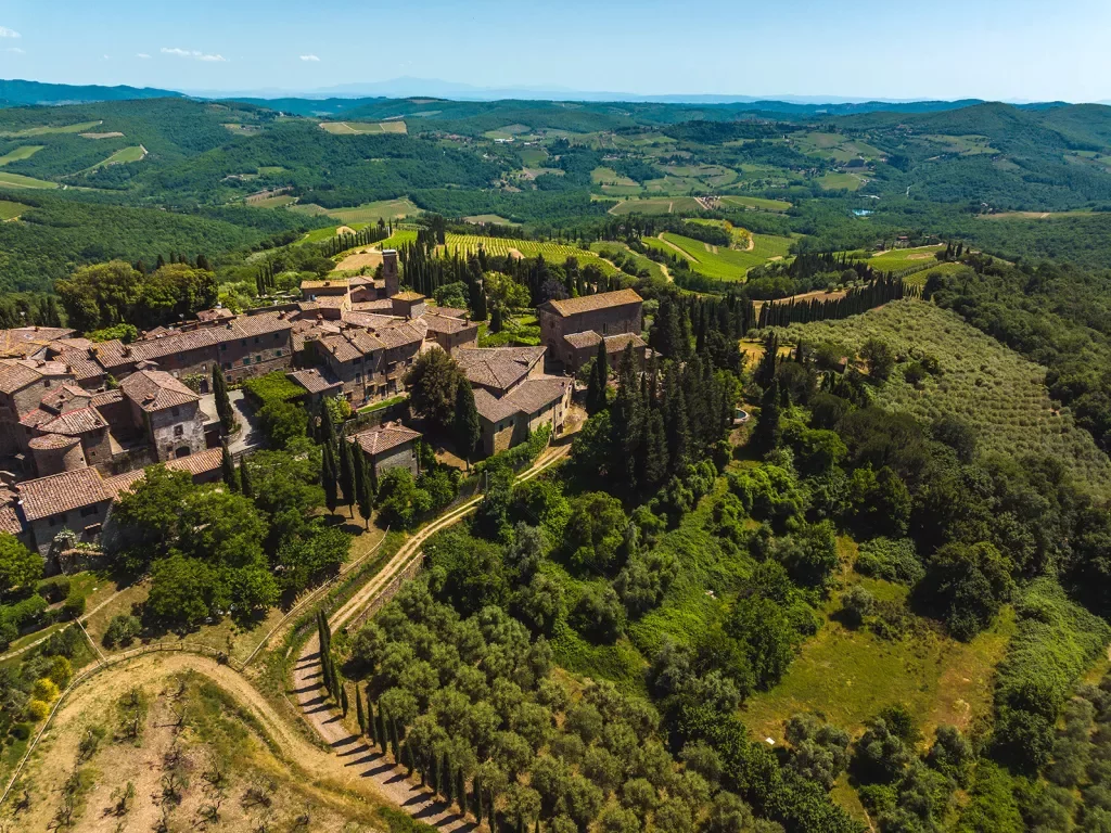 Bird's eye shot of Italian countryside villa and vineyard.