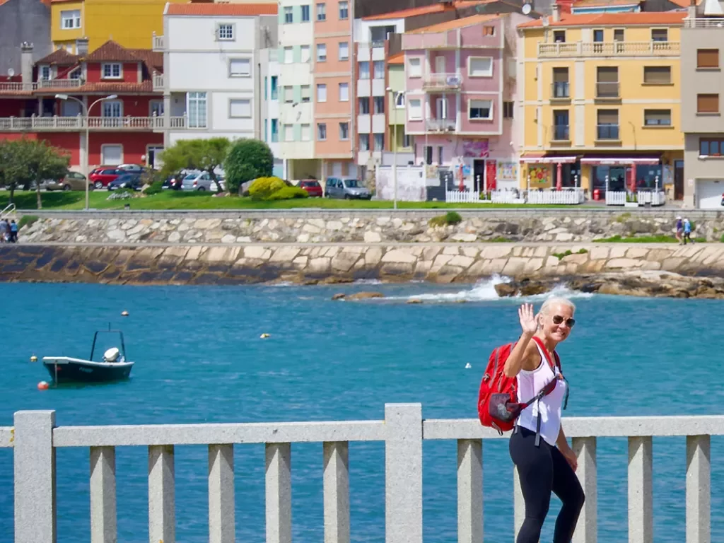 Woman waving on a pier in Portugal