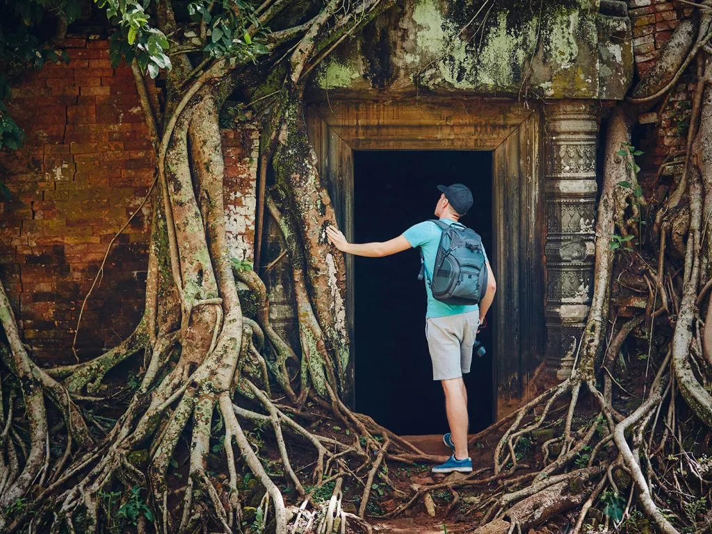Person exploring the temple of Angkor Wat in Cambodia