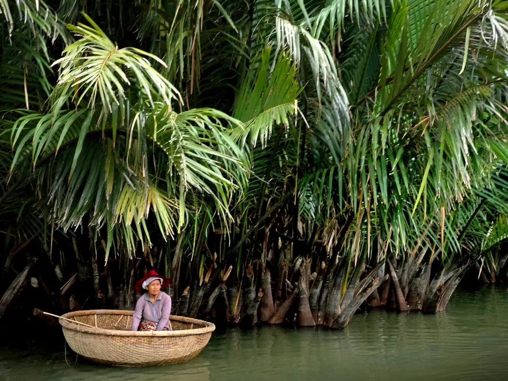 Riding down a jungle river in a round bottomed boat
