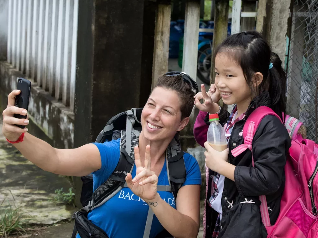 Woman posing and smiling with a child in Vietnam