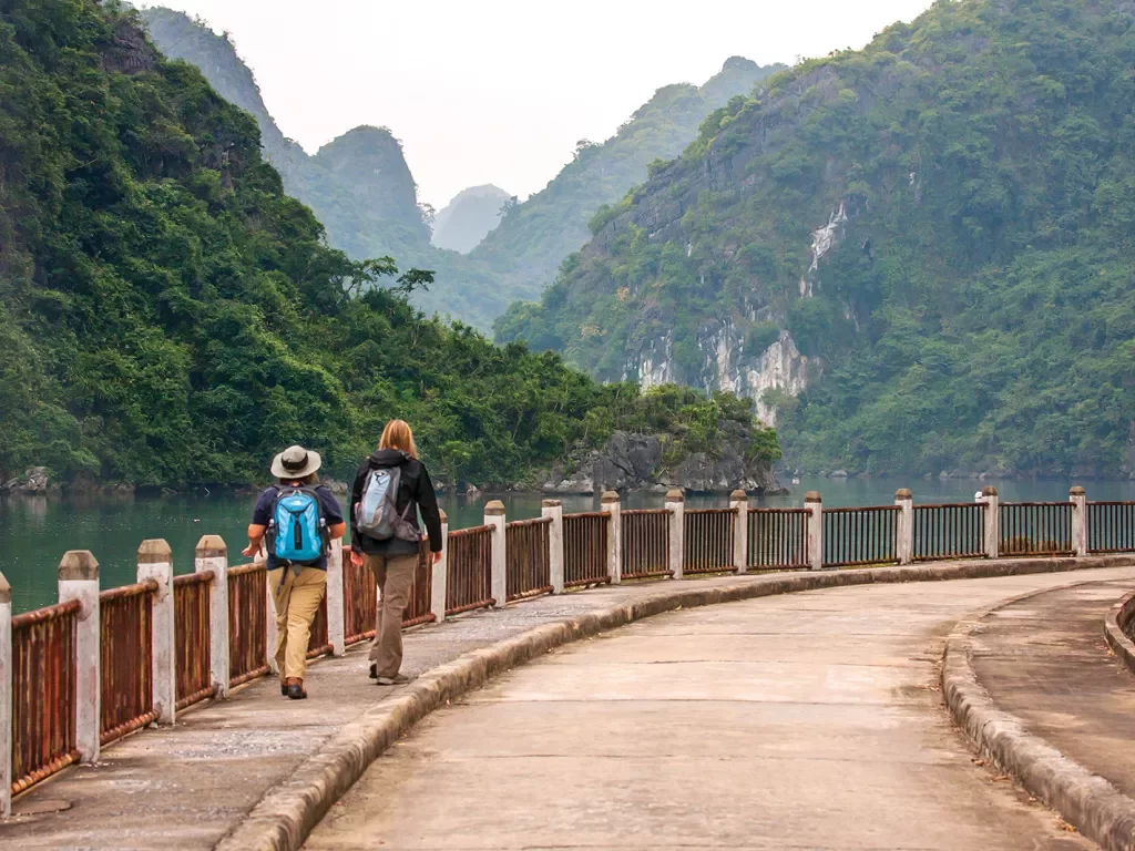 Walking along a stone road in Vietnam with mountains in the background